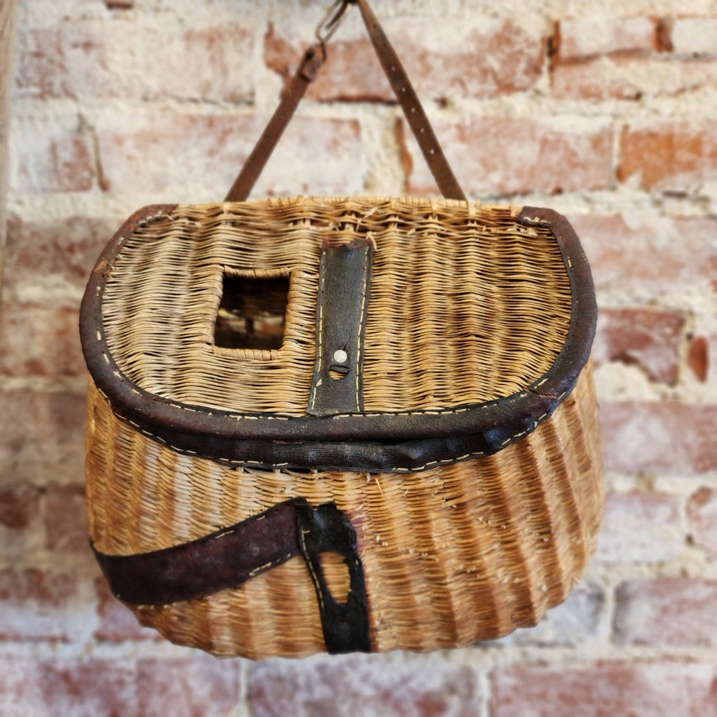 A vintage wicker fishing creel basket, together with two Antique